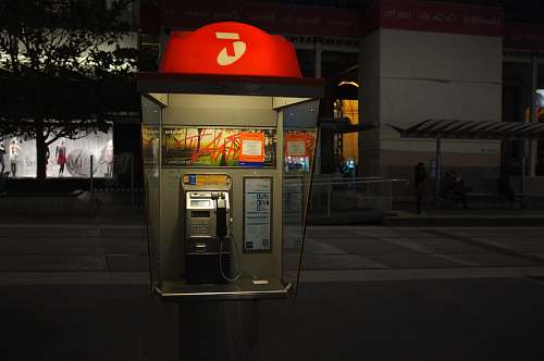window display gray and red telephone post on street melbourne